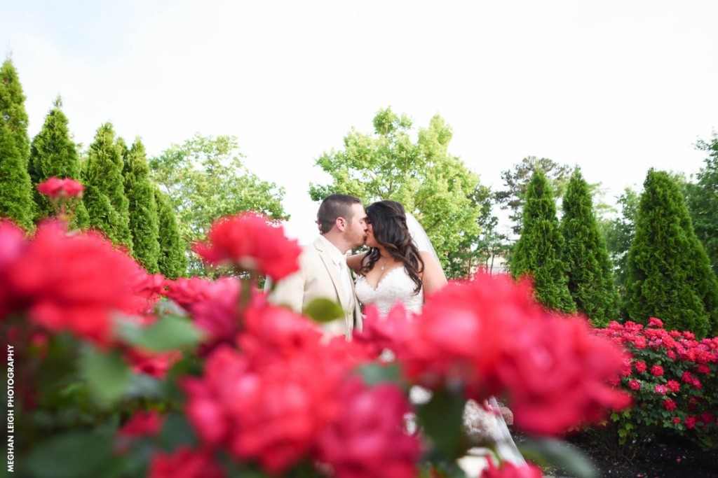 versailles nj couple kiss rose bushes meghan leigh photography